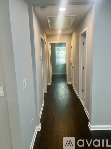 A long hallway with a door at the end.
