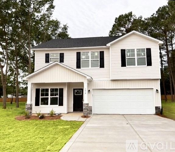 A two-story house with a white garage door and black shutters.