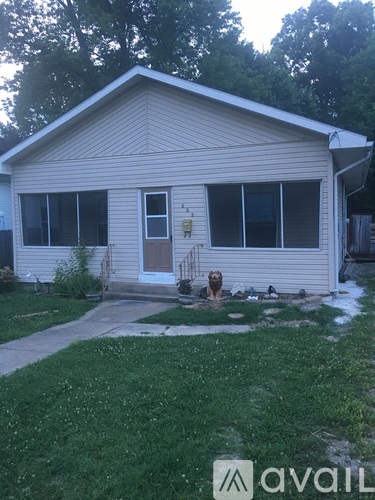 A house with a dog in front of it.