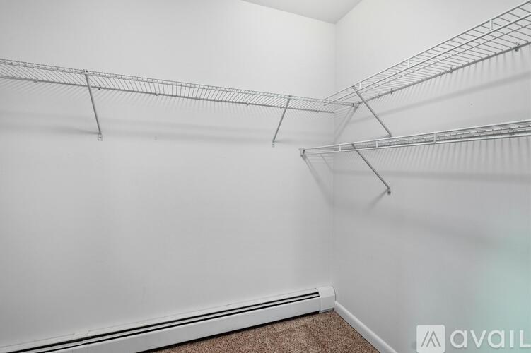 Empty room with white walls and a carpeted floor.