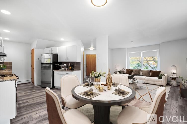 A modern kitchen with a dining table set for two.
