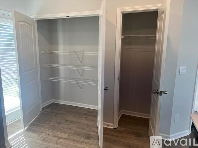 A white closet with shelves and a door.