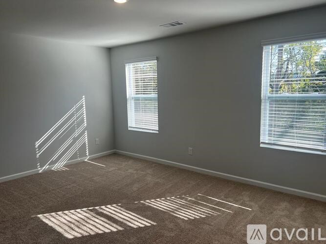 A room with a carpet and a wall with a drawing on it.
