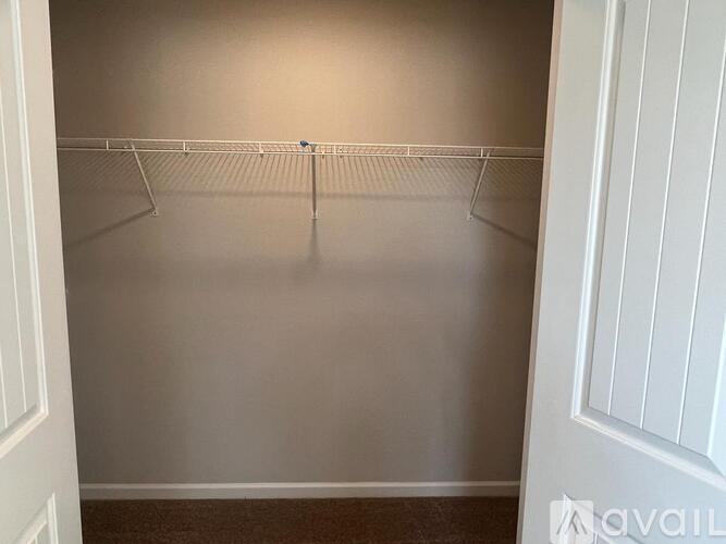 Empty room with a white door and a white shelf.