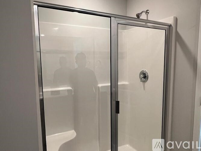 A glass door with a handle and a lock is closed.