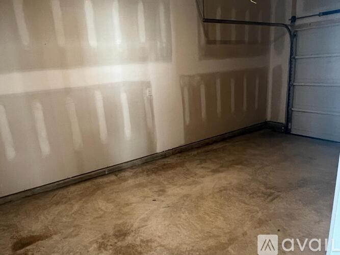 A room with a concrete floor and walls covered in drywall.