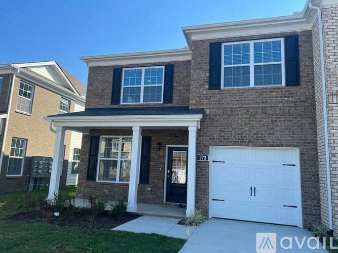 A house with a white garage door is for sale.