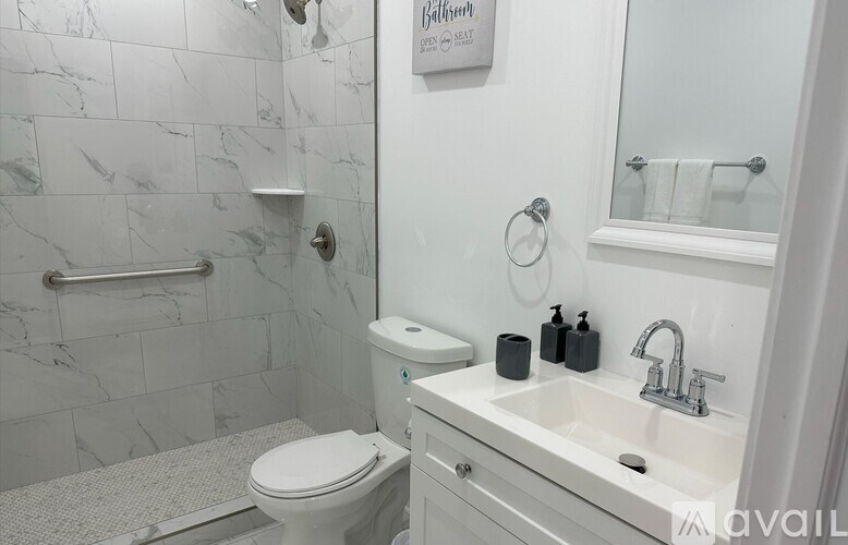 A white toilet sits next to a sink in a bathroom.