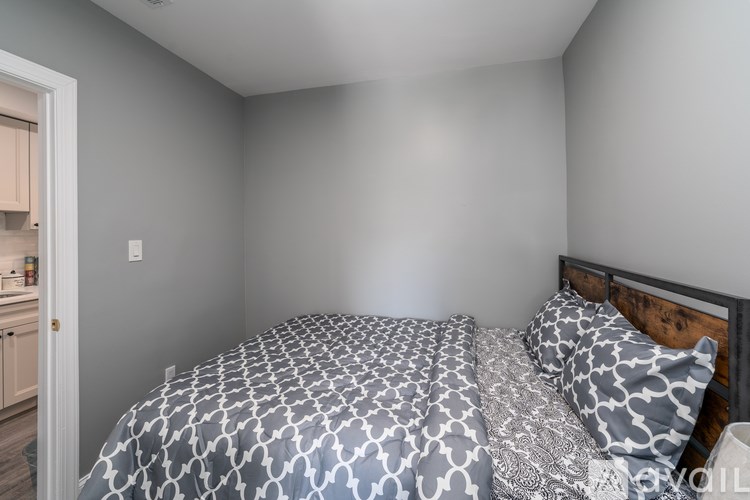 A bedroom with a bed and pillows.