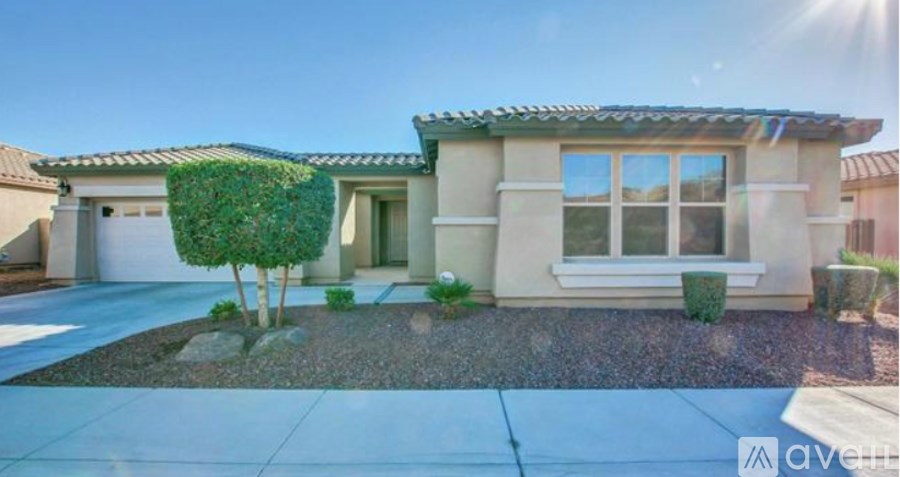 A house with a front yard and a tree.