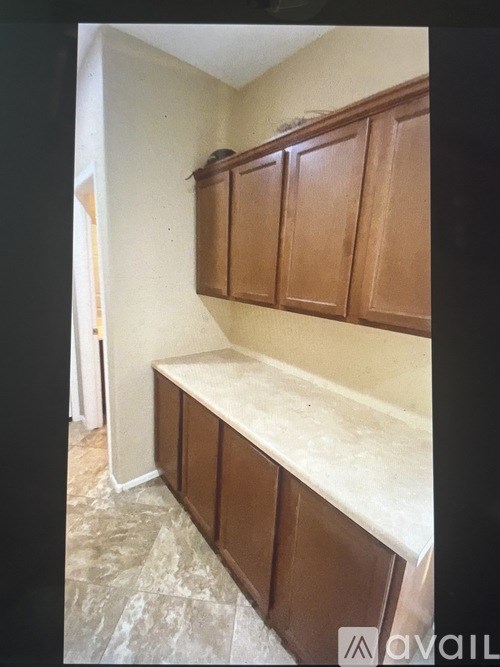 Brown cabinets above a marble counter.