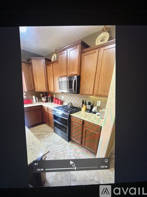 A kitchen with wooden cabinets and a black stove top oven.