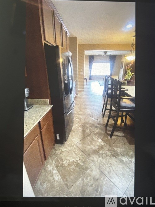 A kitchen with a black fridge and a black dishwasher.