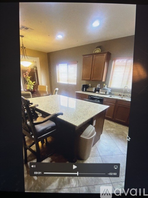 A kitchen with a table and chairs in the foreground.
