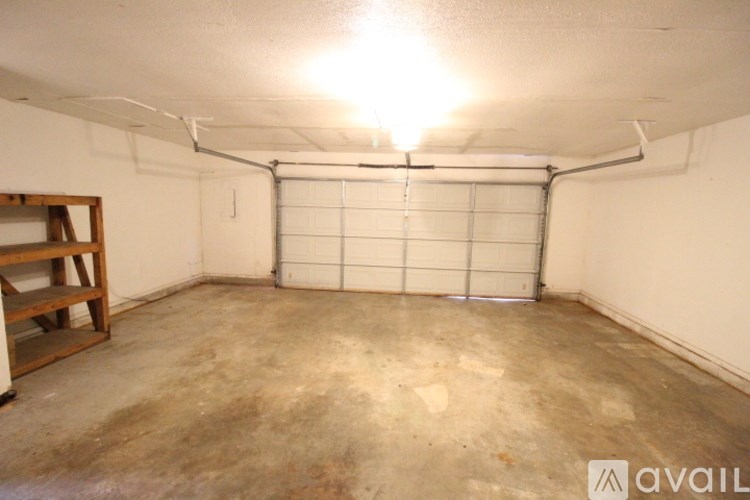 A garage with a white wall and a white door.