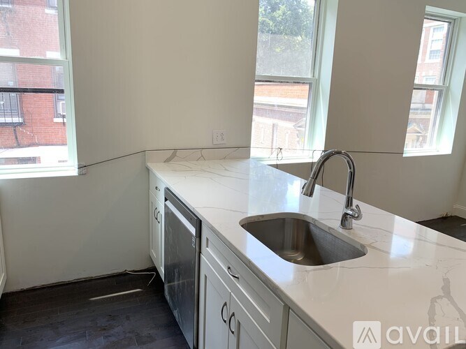 A kitchen with a sink and a window.