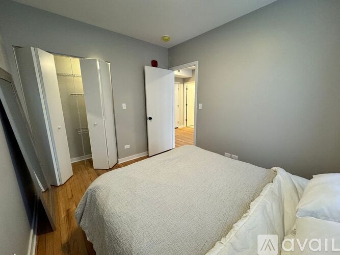 A bedroom with a large bed and a wardrobe.