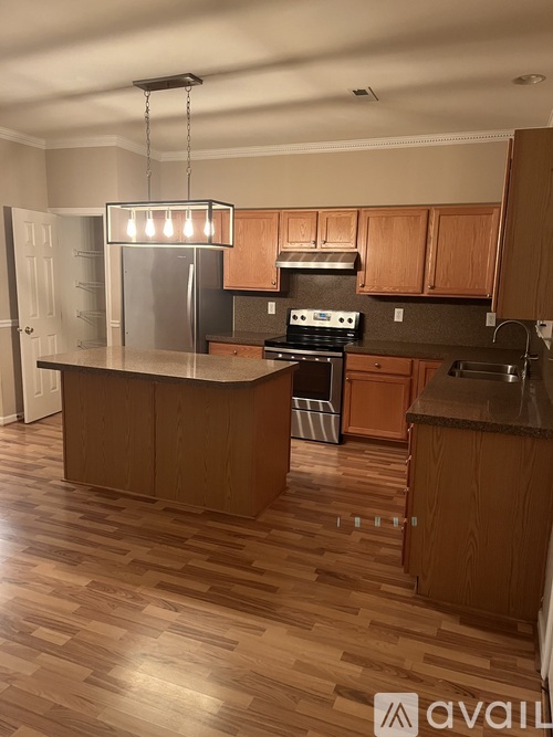 A kitchen with wooden cabinets and a central island.