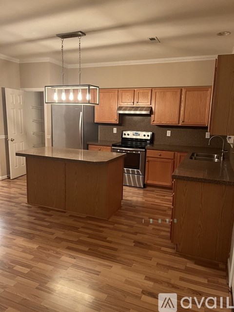 A kitchen with wooden cabinets and a central island.