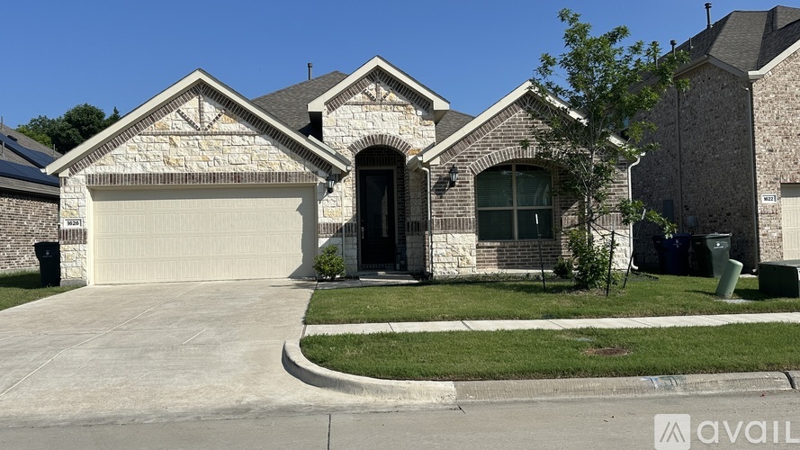 A house with a garage and a driveway in front.