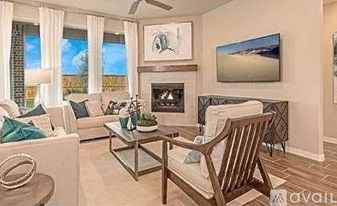 A living room with a fireplace and a painting on the wall.