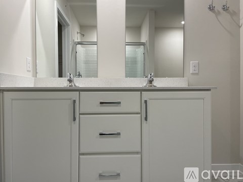 A bathroom with a white cabinet and sink.