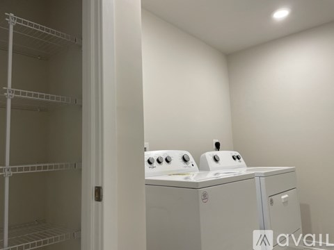 A white ironing board with two irons on top.