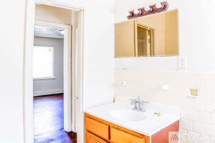 A bathroom with a sink and mirror.