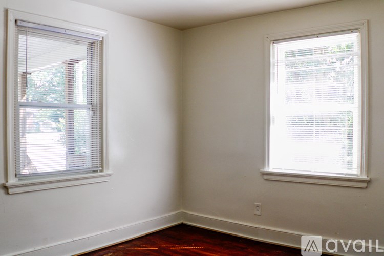 A room with a window on the left and a window on the right.