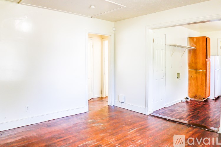 A room with a wooden floor and white walls.