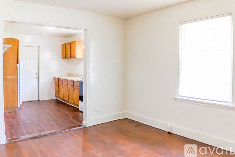 A room with wooden floors and white walls.
