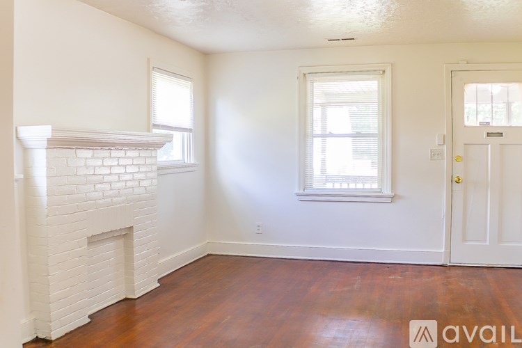A room with a fireplace and a door.