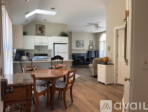A kitchen with a table and chairs in the middle of the room.