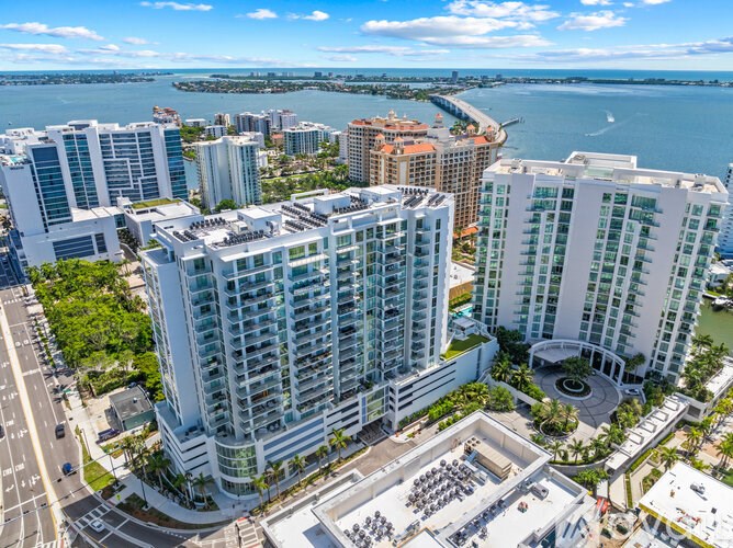 A cityscape with a large body of water in the background and a clear sky.