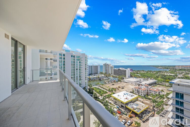 A balcony overlooks a construction site and a cityscape.