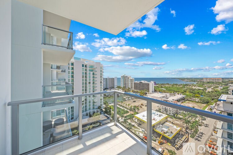 A balcony overlooks a construction site and a cityscape.