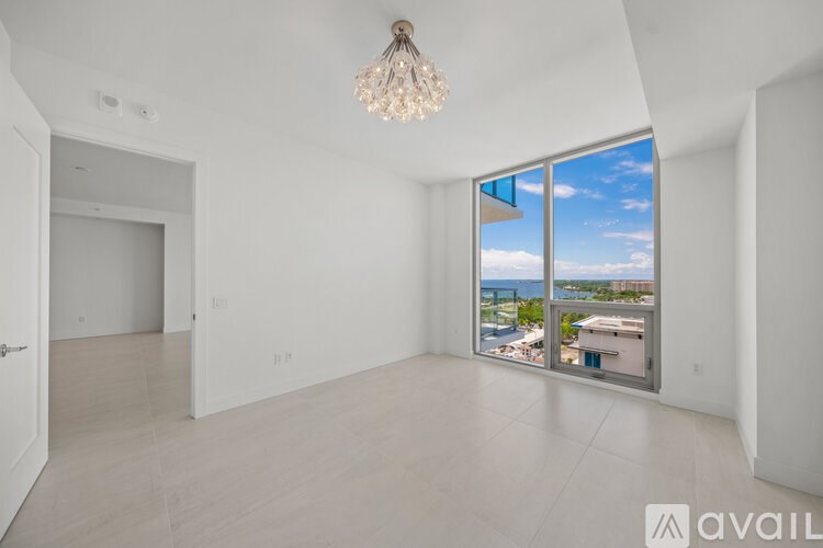A room with a large window overlooking a cityscape.