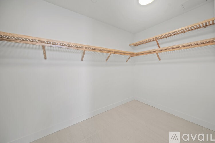 Empty room with three wooden shelves.
