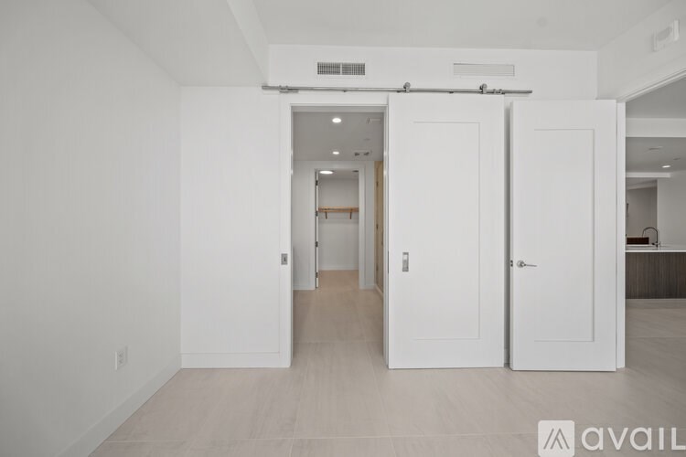 A room with white walls and a white floor with a white door.