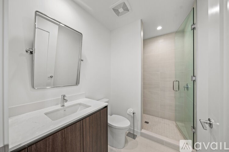 A bathroom with a sink, toilet, and shower.