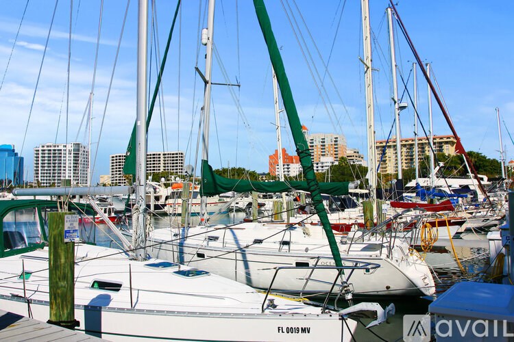 A boat with the label FL 0019 MV is docked at a marina.