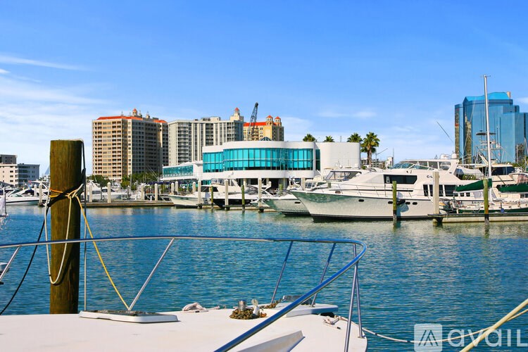 A view from a boat of a cityscape with buildings and boats docked in the water.