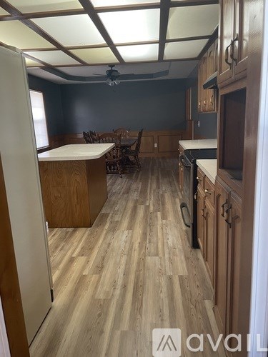 A kitchen with wooden floors and furniture.