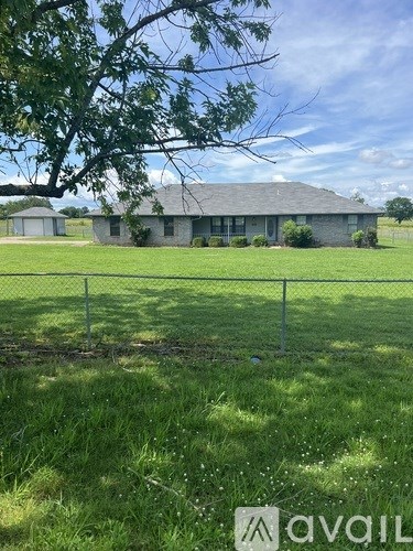 A house with a fence in front of it.