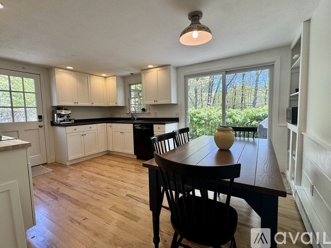 A kitchen with a table and chairs in the middle of the room.