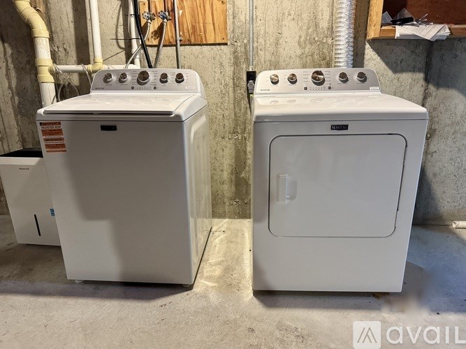 Two white ovens are sitting next to each other.