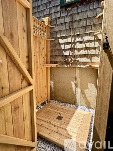 A wooden deck is being built in a backyard.