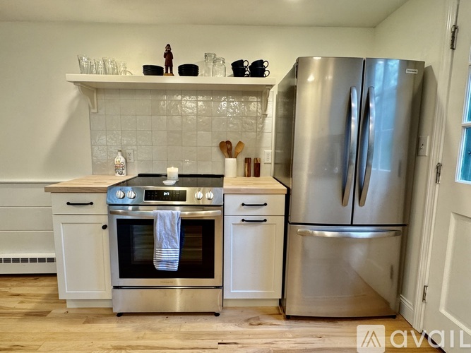 A kitchen with a stainless steel refrigerator and oven.