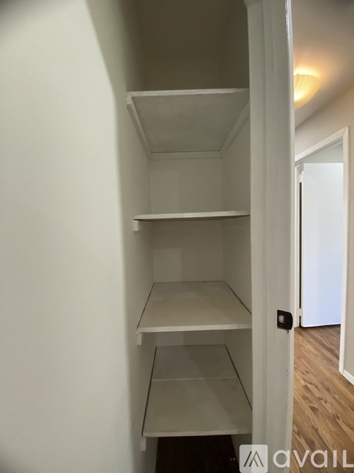 Empty white shelves in a room.
