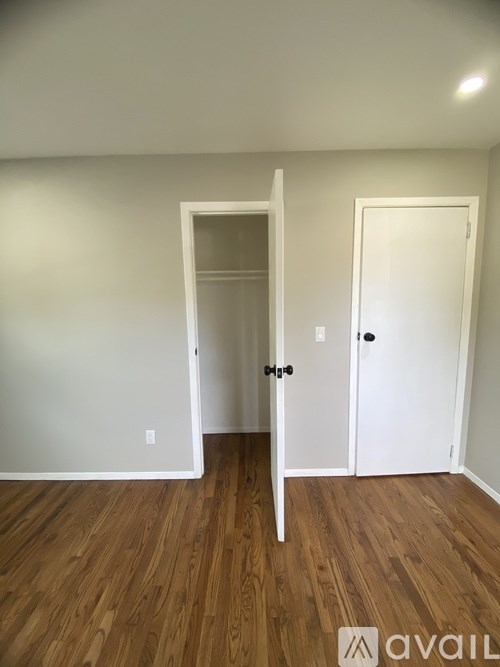 A room with a white door and a white wall.